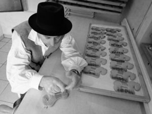 The owner decorating the gingerbreads with royal icing