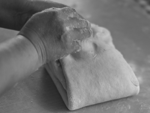 Picture showing the owner folding the dough