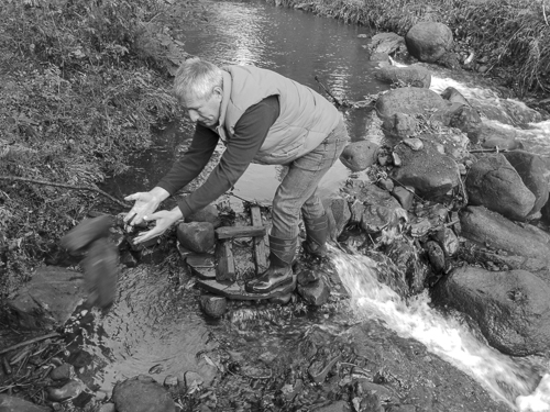 Picture showing the owner removing stones from a river